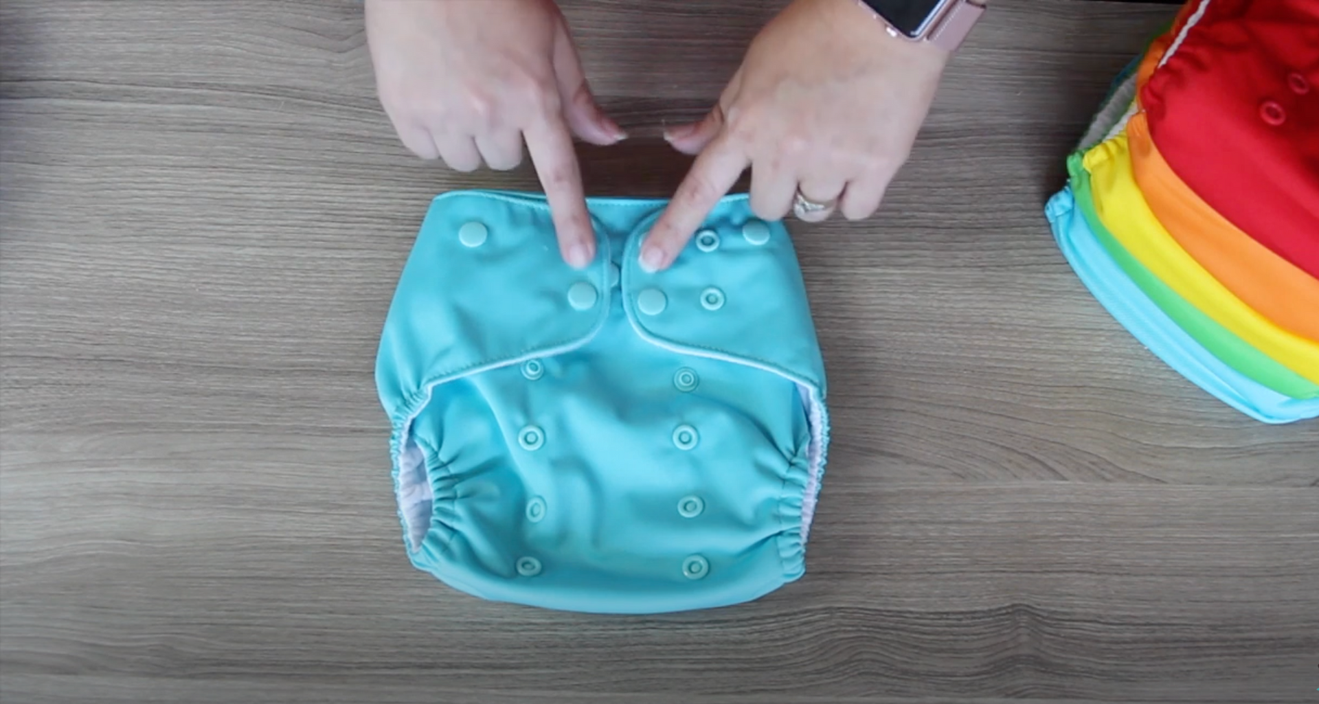 Load video: Our one size cloth diaper video describes how to use the diaper in detail.